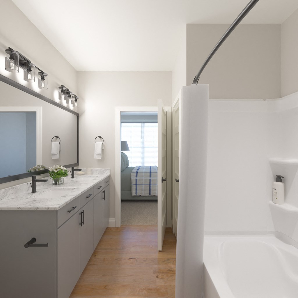 a bathroom with a tub and a sink and a mirror