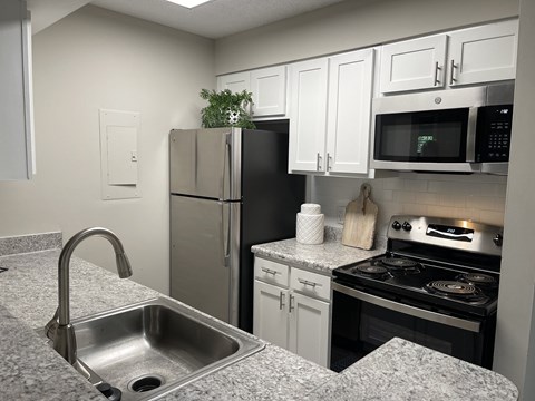 a kitchen with stainless steel appliances and granite counter tops