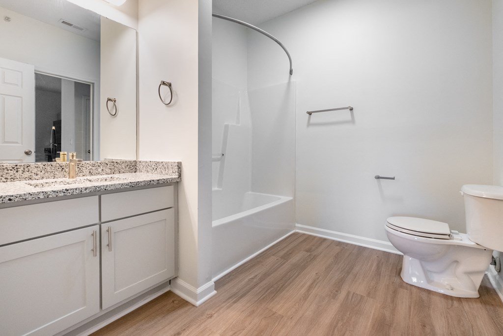 a bathroom with a toilet and a shower and a sink