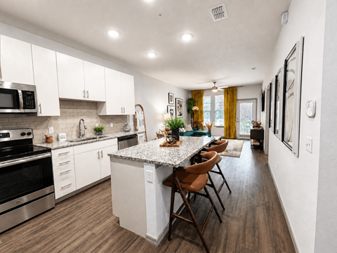 A modern kitchen with a dining table and chairs.