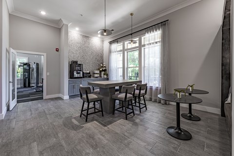 A dining room with a table and chairs.