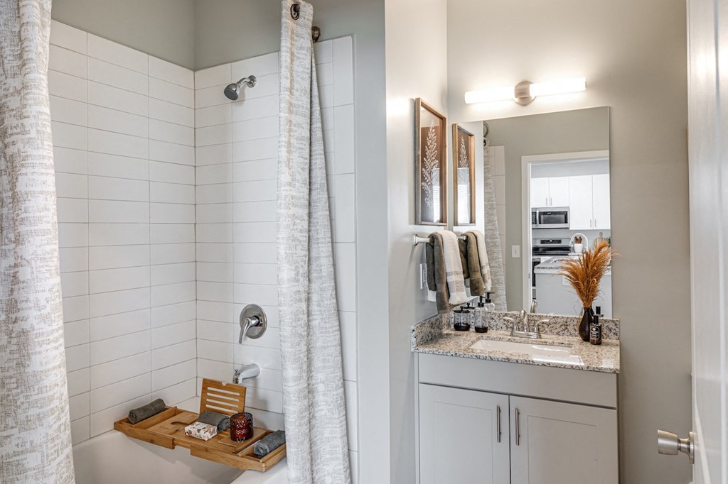 a small bathroom with a shower and a sink