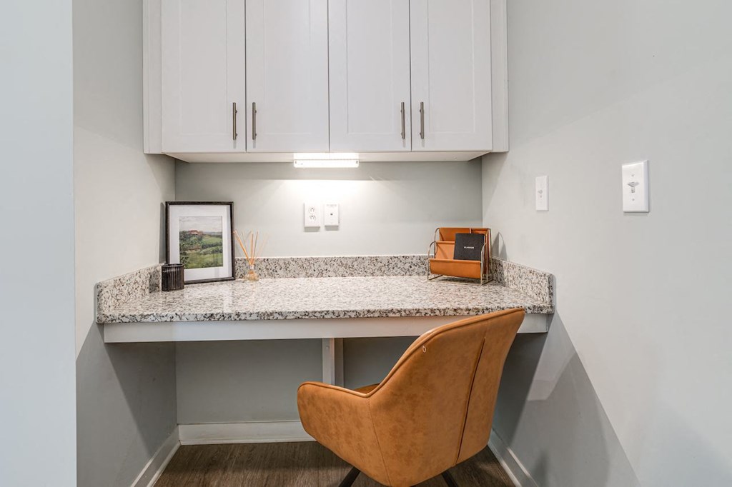 an office with a desk and a chair under a counter