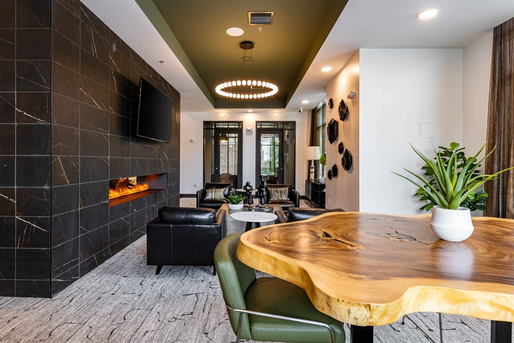 a living room with a fireplace and a wooden table
