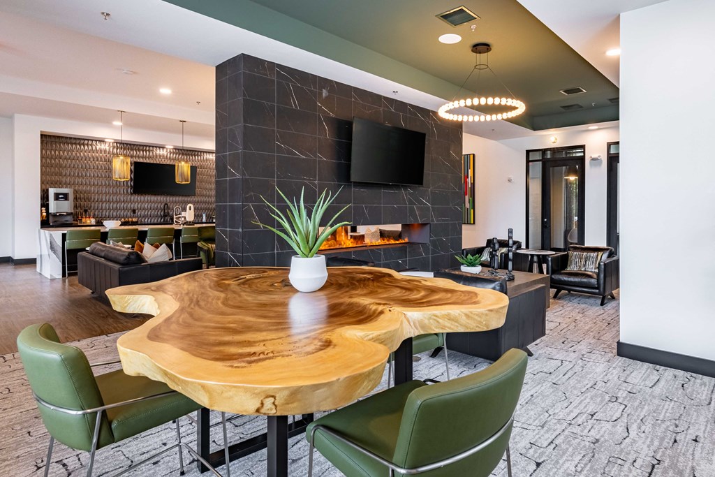 a conference room with a table and chairs and a television