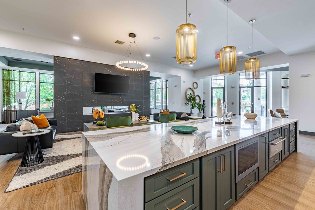a large kitchen with an island and a living room with a tv