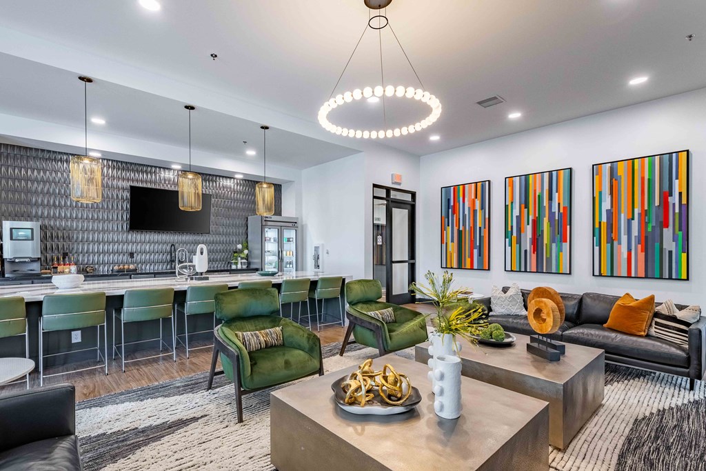 a living room with a kitchen and a table with chairs