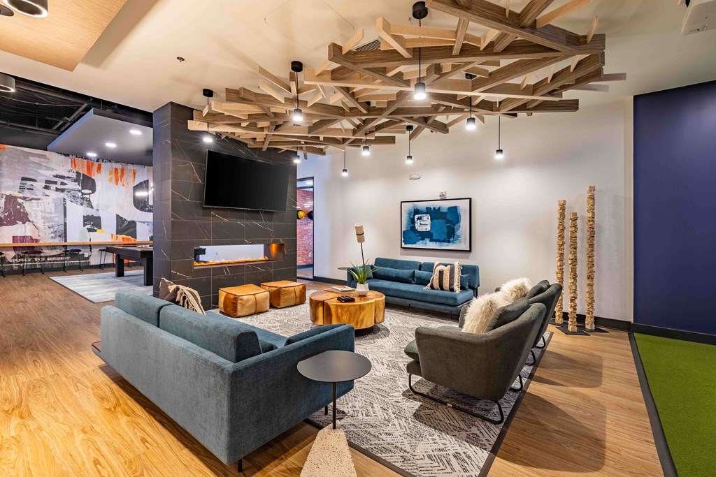 a living room with couches and chairs and a fireplace