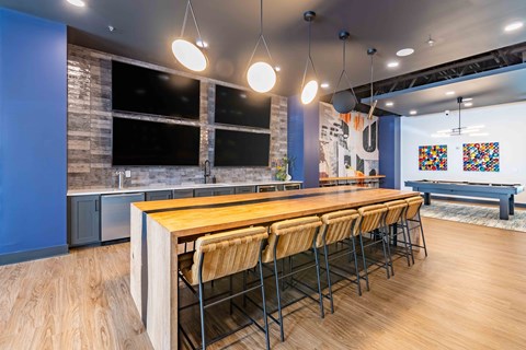 a dining room with a long wooden table and chairs