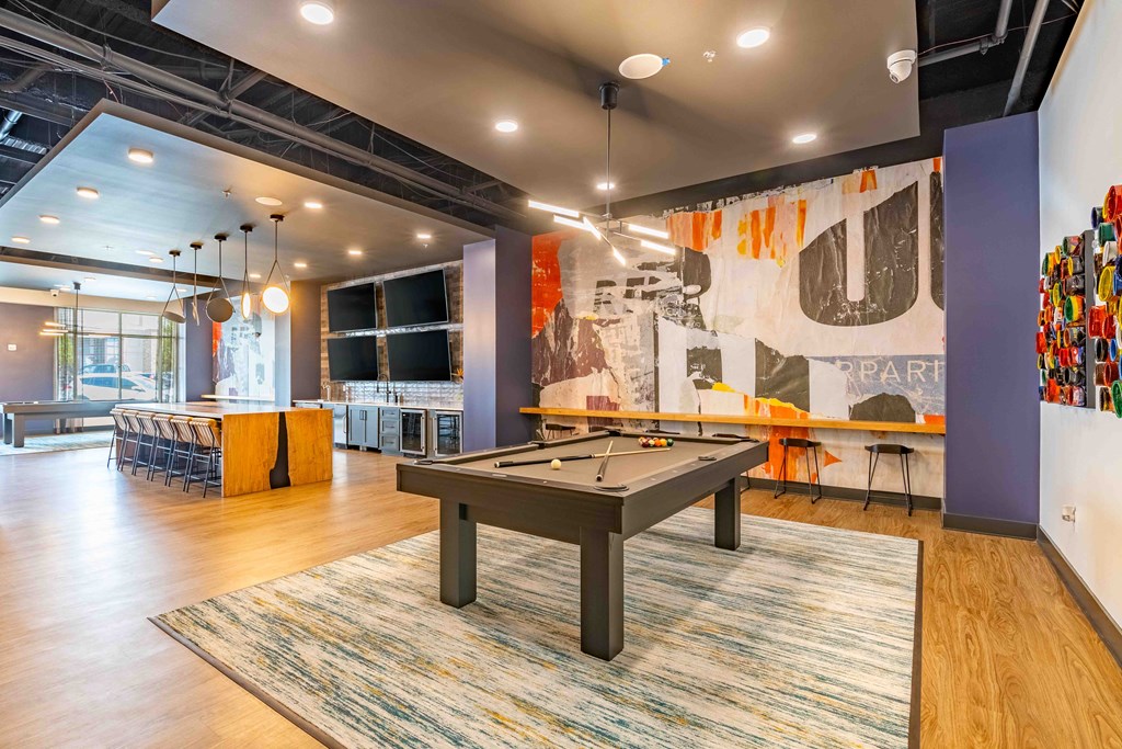 a games room with a pool table and a bar