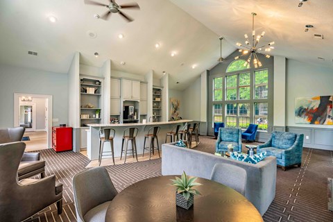 a living room with a kitchen and a table and chairs