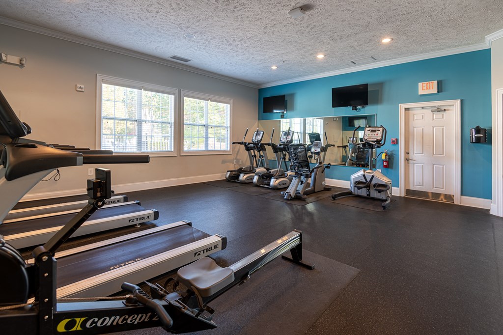 a gym with treadmills and other exercise equipment at the enclave at woodbury