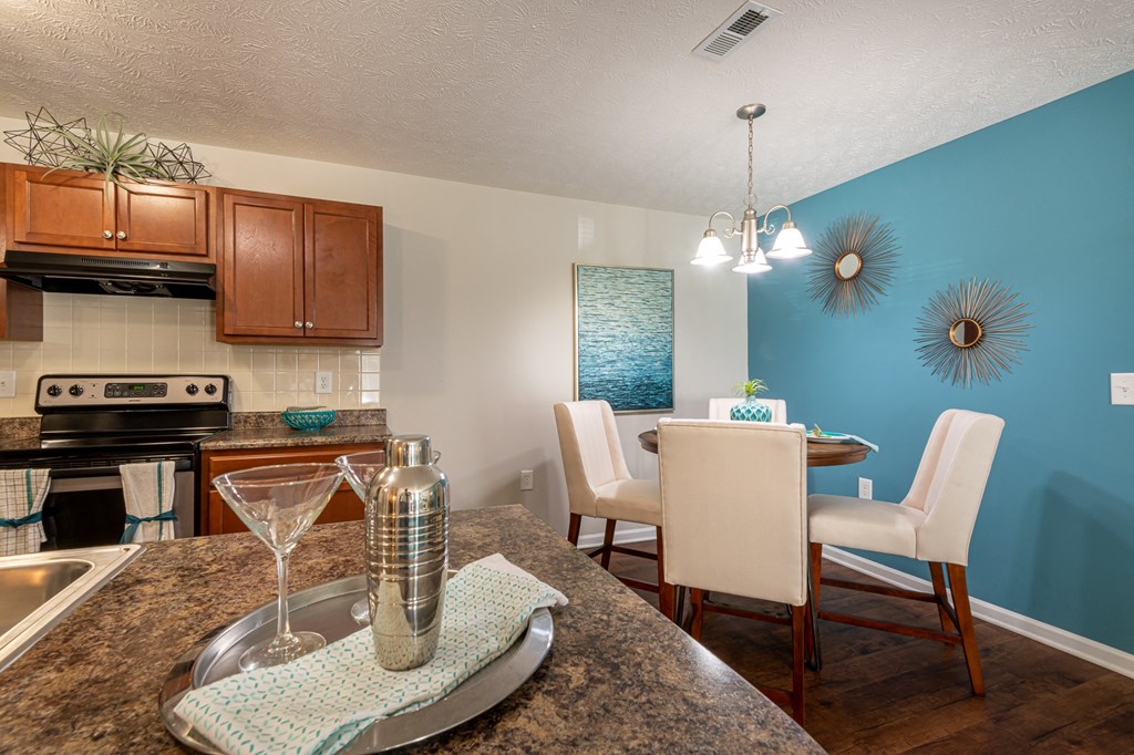 an open kitchen and dining area with a table and chairs