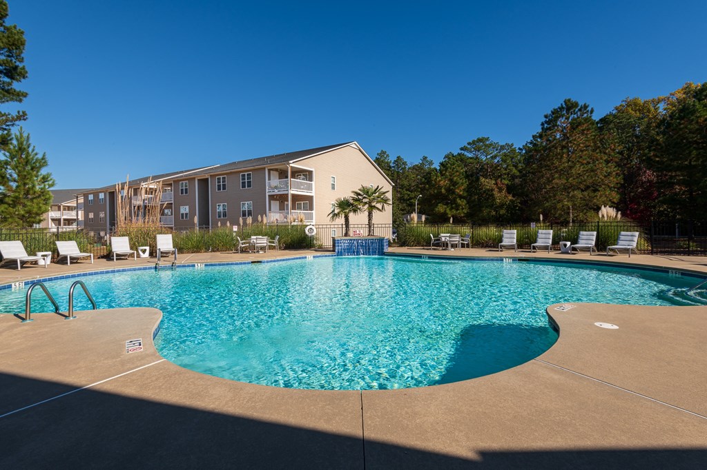 our apartments offer a swimming pool with an apartment building in the background