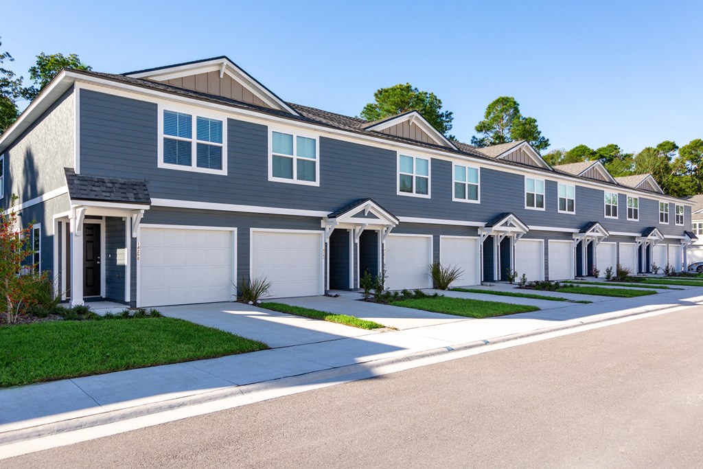 A row of houses with grey and white exteriors.