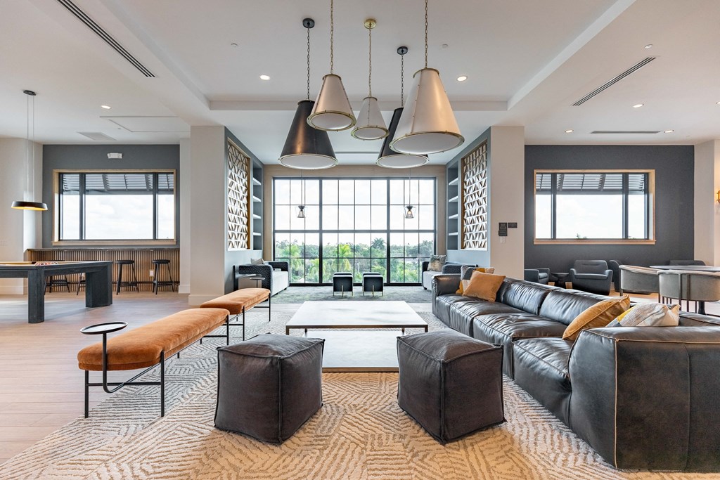a large living room with couches and chairs and a coffee table