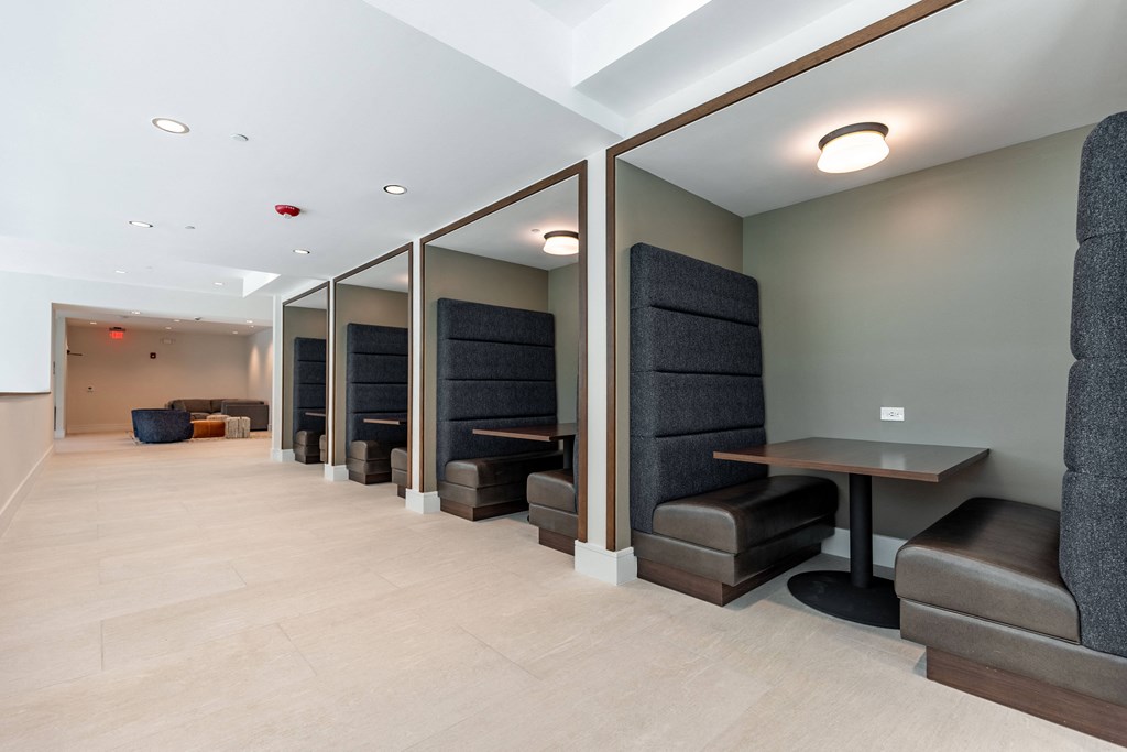 a long hallway with chairs and tables and mirrors