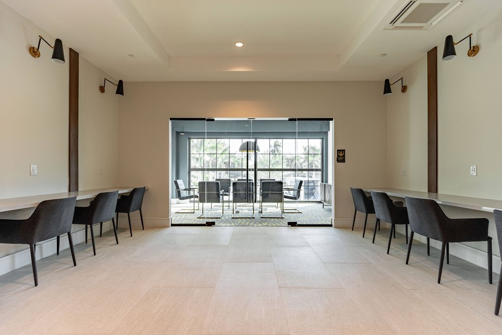 a conference room with chairs and a table and a large window