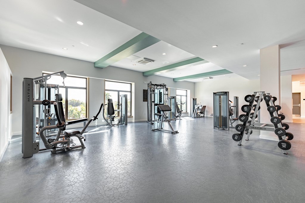a gym with weights and other exercise equipment in a building