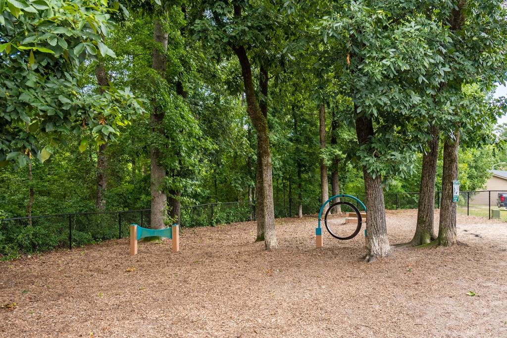 a playground with trees and a bike in the middle