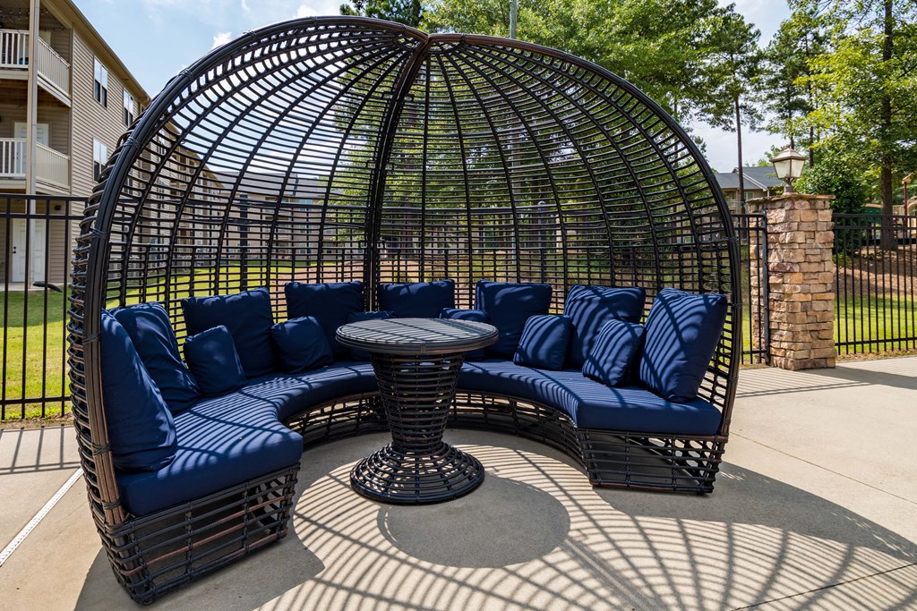 an outdoor patio with blue couches and a table