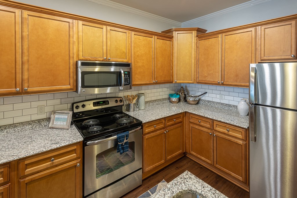 a kitchen with stainless steel appliances and wooden cabinets