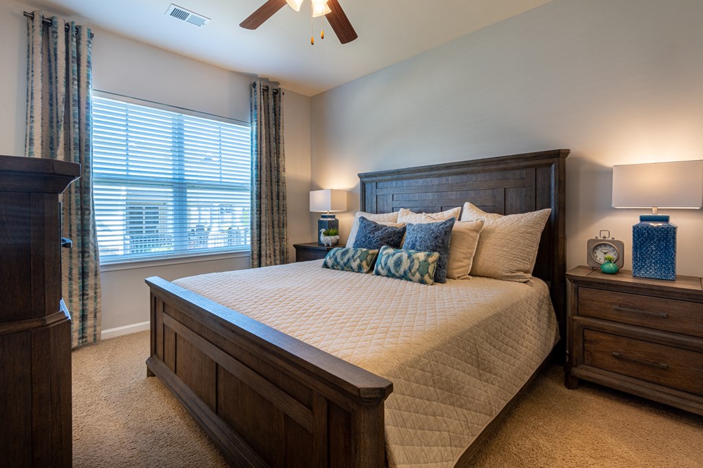 a bedroom with a large bed and a window