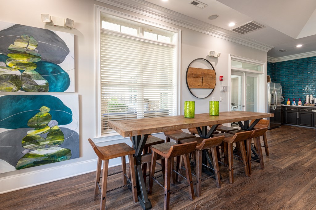 a dining room with a wooden table and chairs