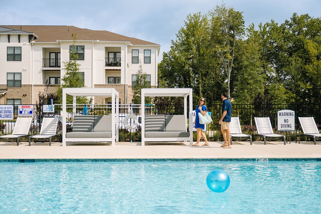 Amenities A swimming pool with a warning sign and two people standing by it.
