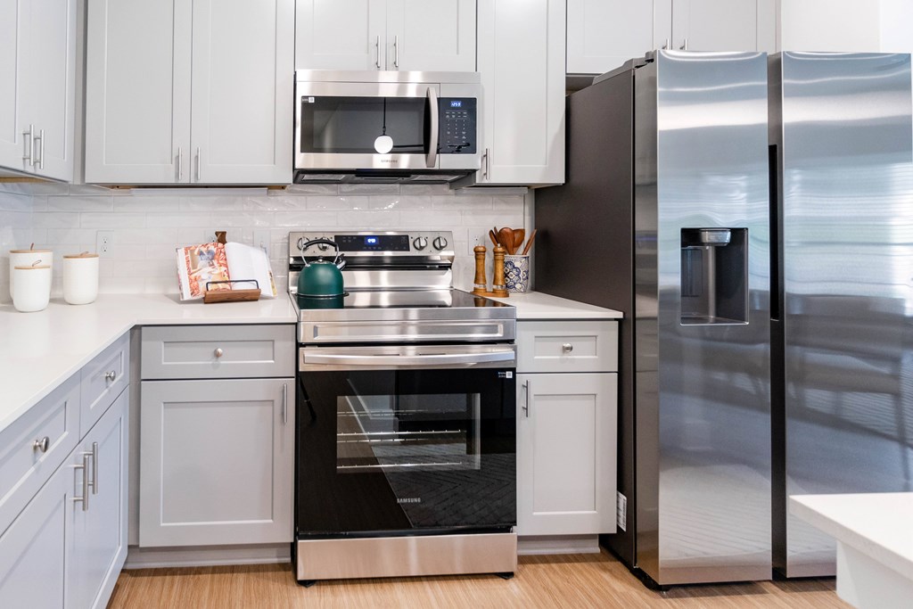 Kitchen with a stainless steel refrigerator and oven.