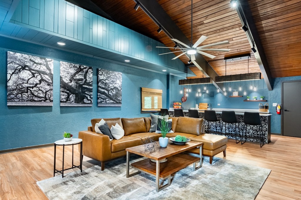 a living room with blue walls and leather furniture
