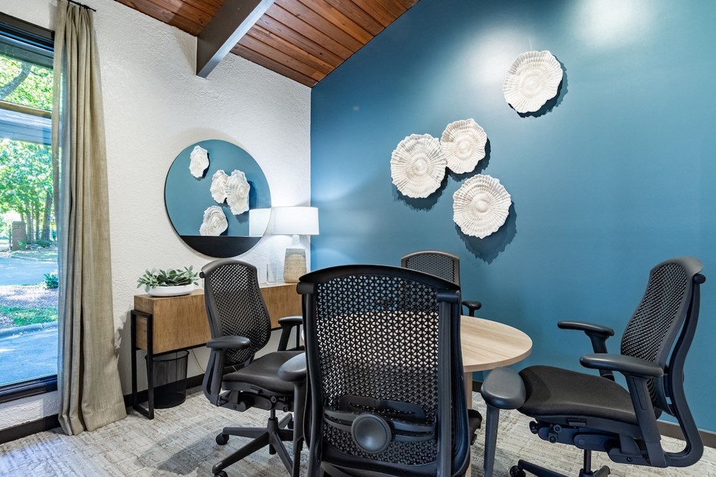 a conference room with a table and chairs and a window