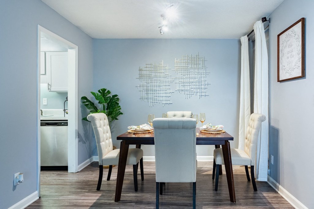 a dining room with a table and chairs