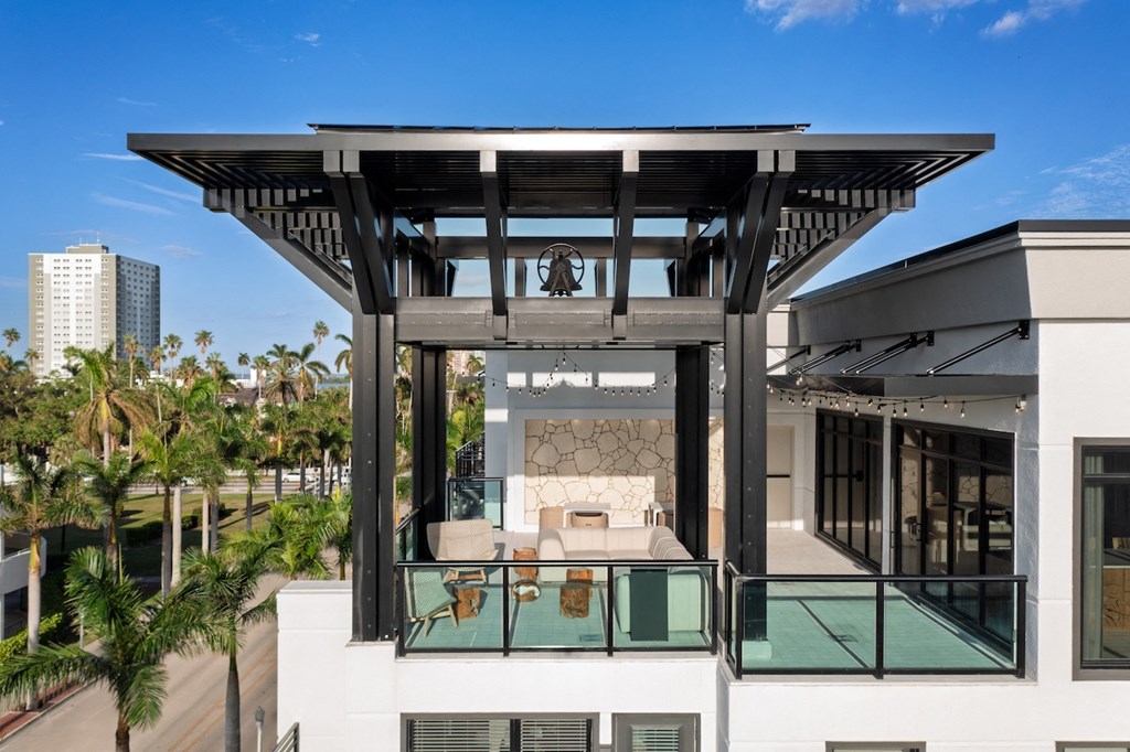 A modern house with a balcony and a glass railing.