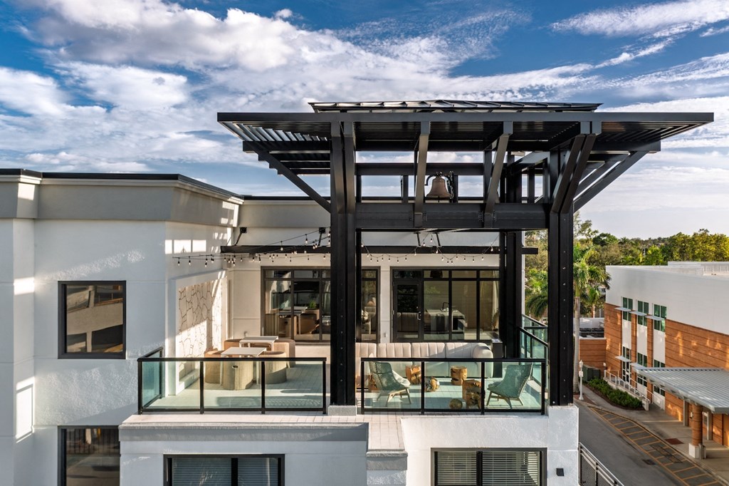 A modern house with a balcony and a glass table.