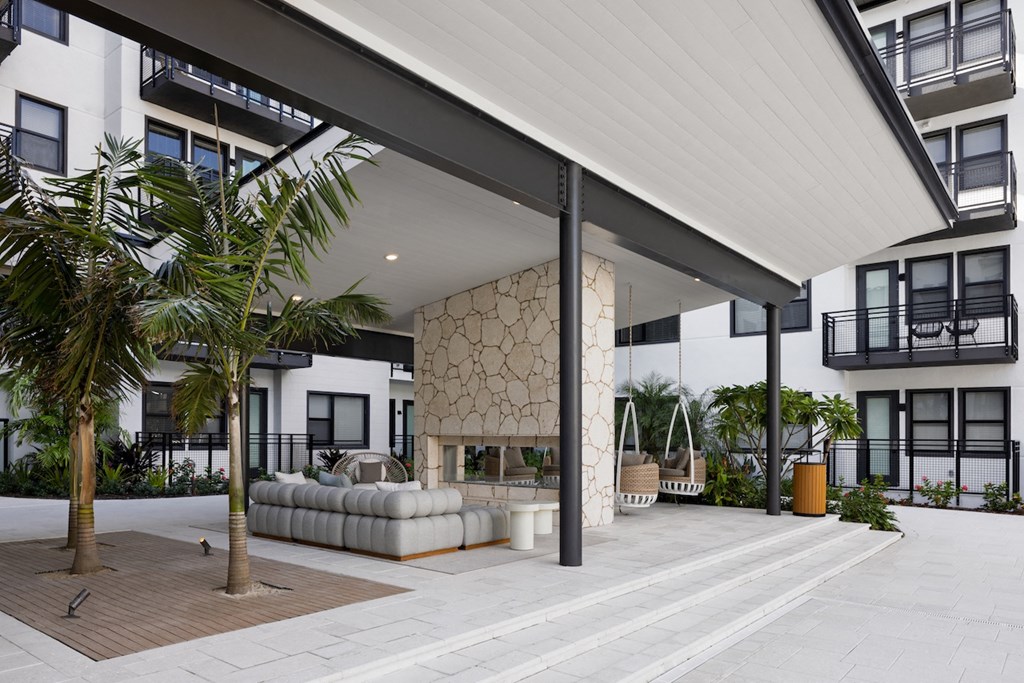 A modern building with a white exterior and a balcony.