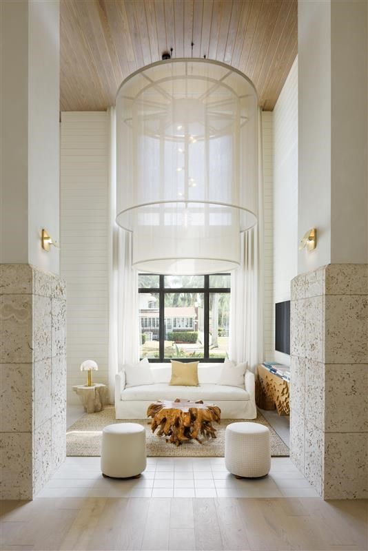A dog is sitting on a rug in a white room.