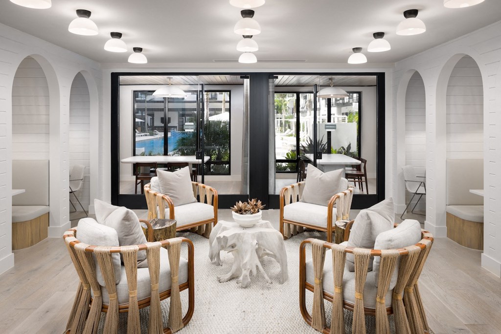 A modern living room with a large window and a view of a pool.