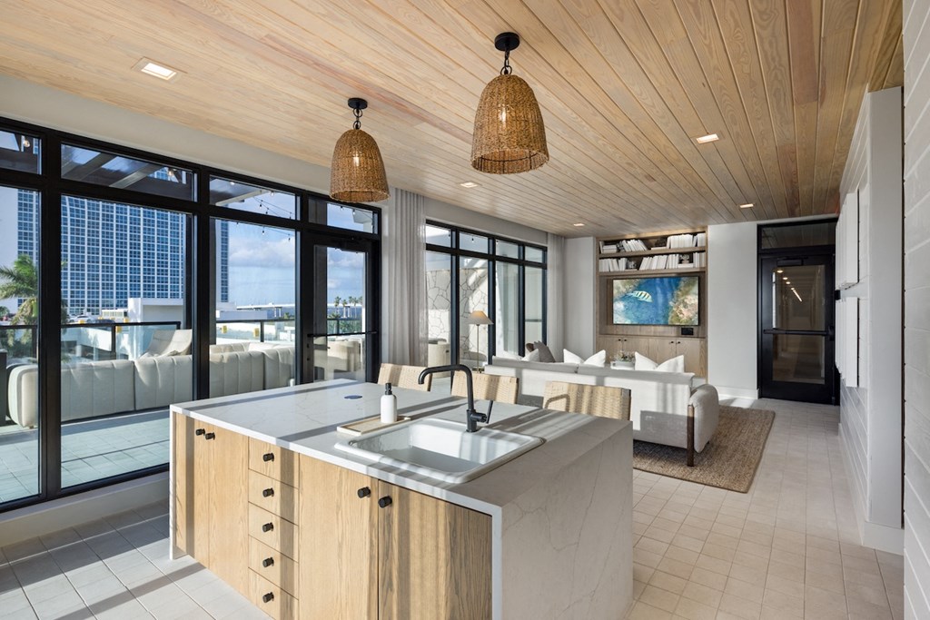 A modern kitchen with a wooden ceiling and a large island.