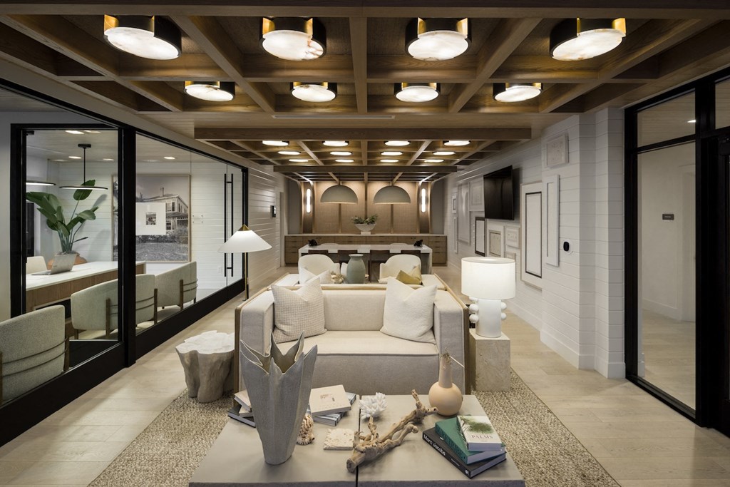 A modern living room with a white sofa and a coffee table.