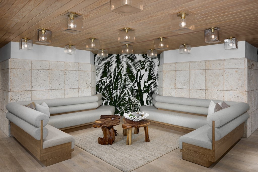 A modern living room with a large tapestry hanging on the wall.