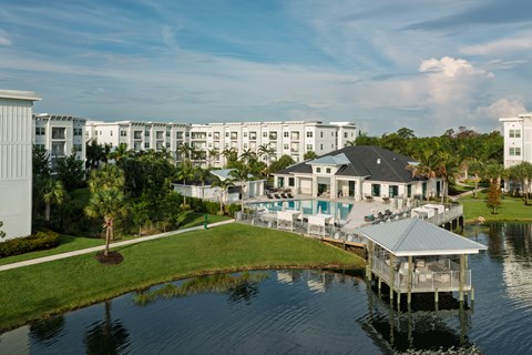 A house is situated on the water with a dock.
