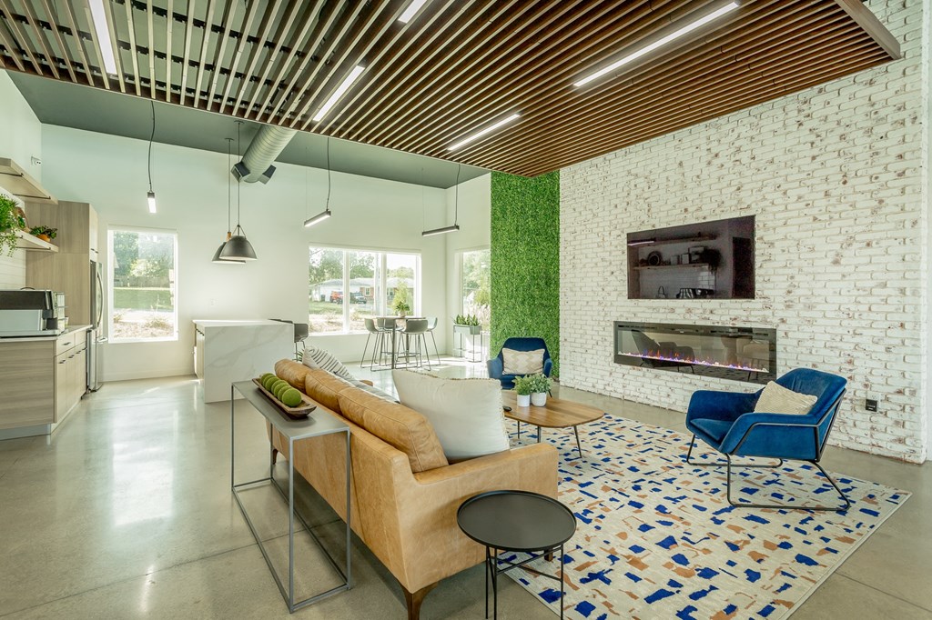 a living room with a couch and chairs and a fireplace