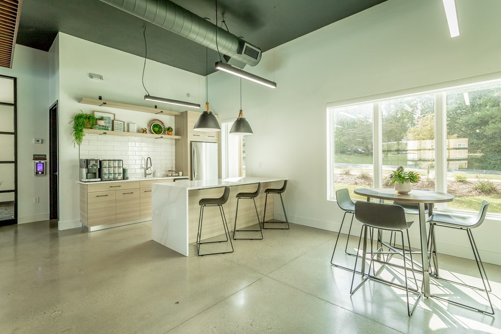 a kitchen and dining area with a large window and a table and chairs