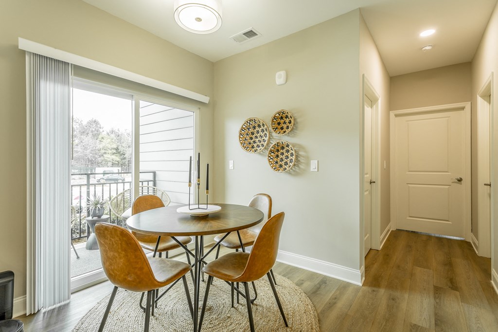 a dining room with a table and chairs and a window