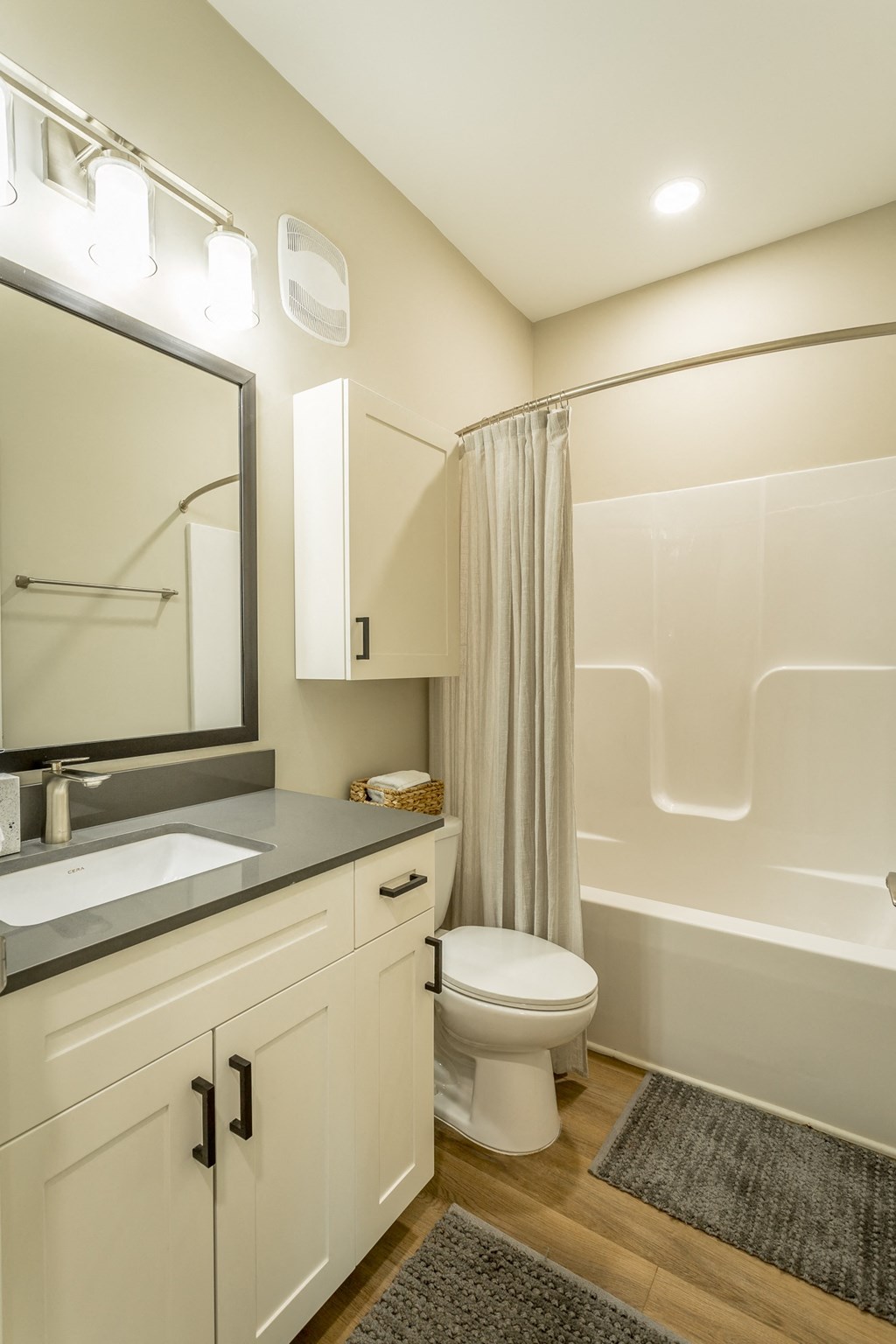 a bathroom with a toilet and a sink and a shower