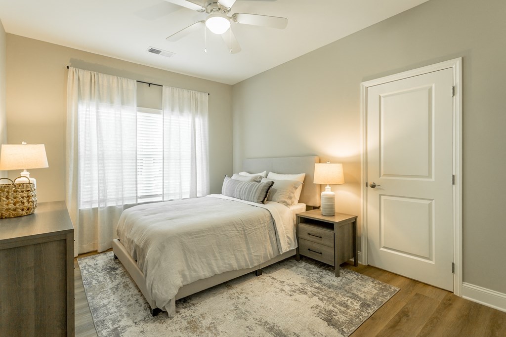 a bedroom with a bed and a ceiling fan