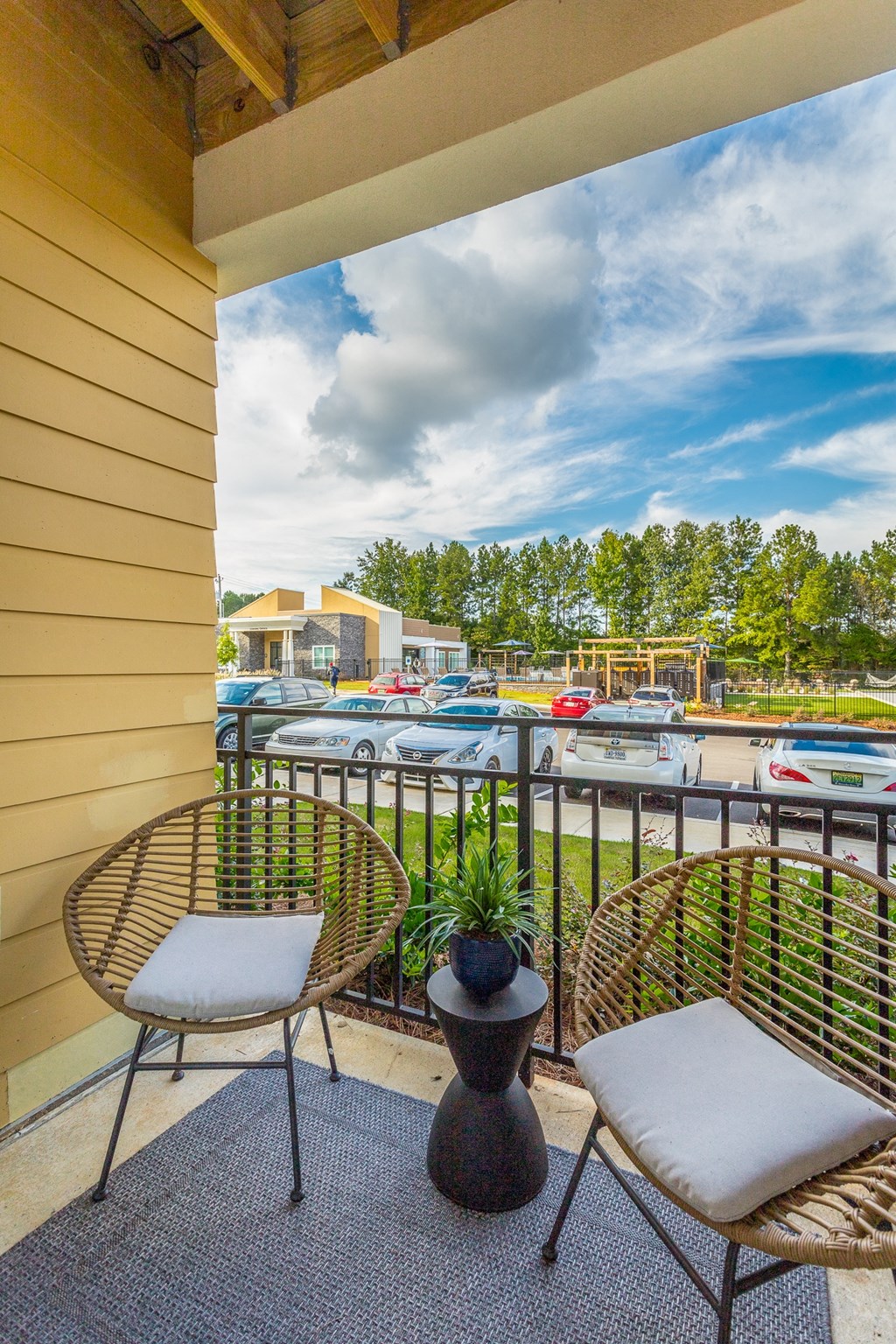 a balcony with two chairs and a view of a marina