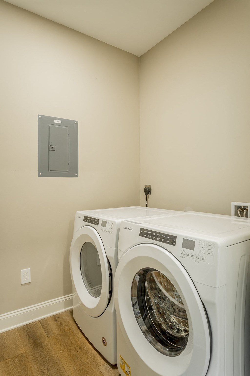 a front loading washer and dryer in a laundry room with a door