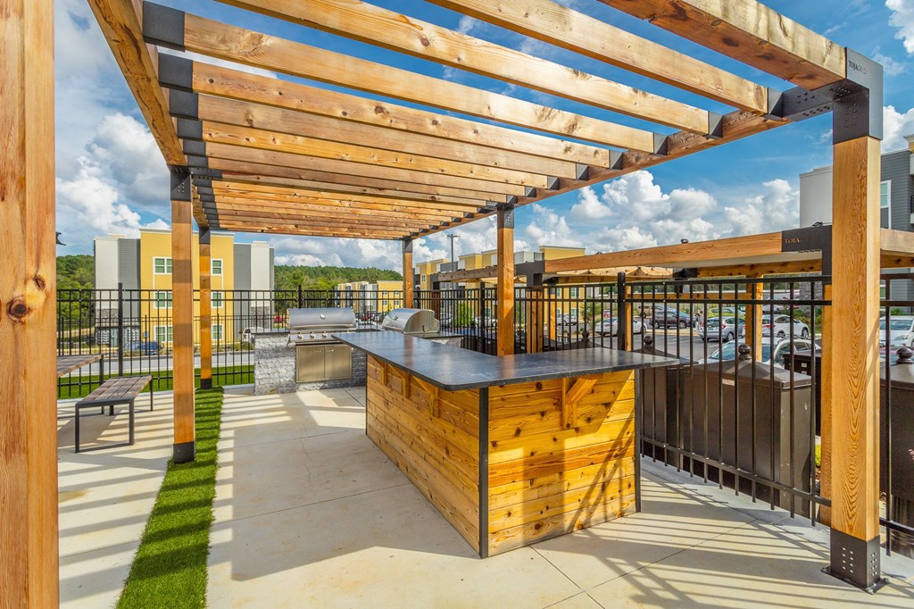 the private patio of a building with a bar and wooden structures